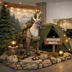 Decorative display with a deer statue, camping gear, and 'Adventure Awaits' sign in a room. by Jet Creations
