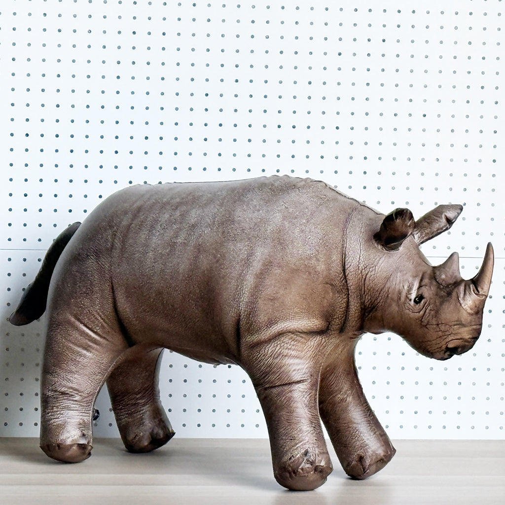 Jet Creations inflatable rhino toy on a white surface with a white pegboard background